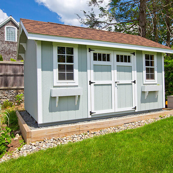 New blue garden shed in beautiful garden